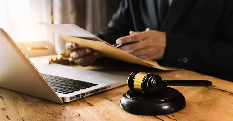 Judge's gavel and laptop on a desk