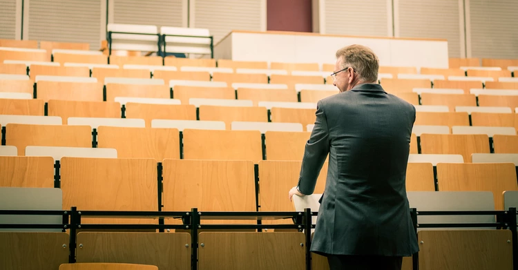 Man in an empty lecture theatre