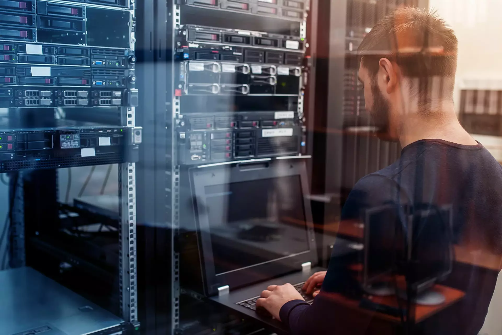 Employee standing in front of server rack